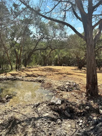 an aerial view of residential house with parking and yard