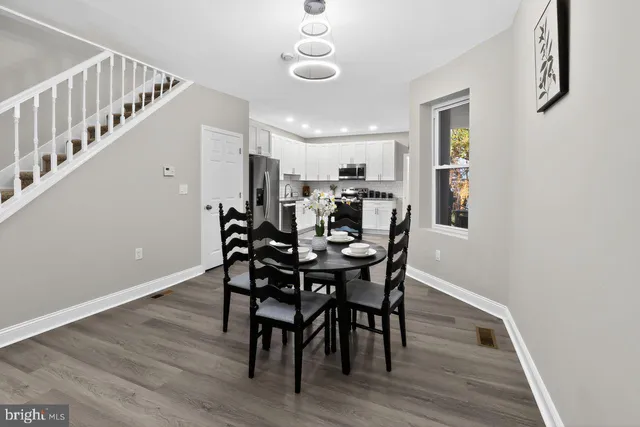 a view of a a dining room with furniture window and wooden floor