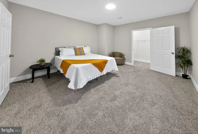 a bedroom with a bed and a potted plant