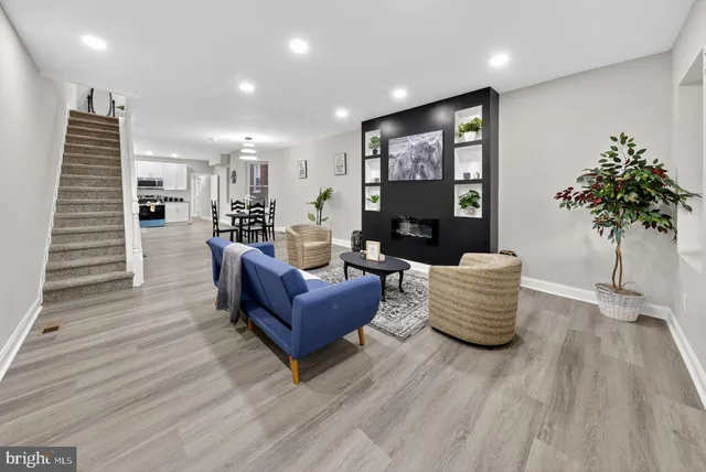 a living room with furniture and a potted plant