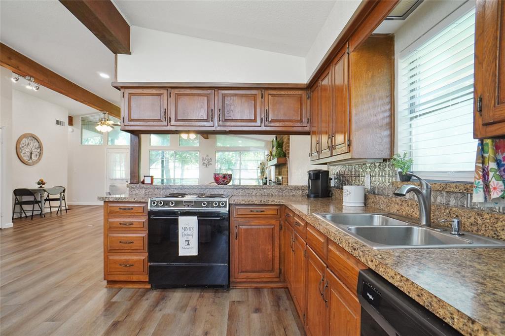 308 Half Moon Way Runaway Bay, TX 76426 - Photo 40 of 40 a kitchen with stainless steel appliances granite countertop a stove and a sink
