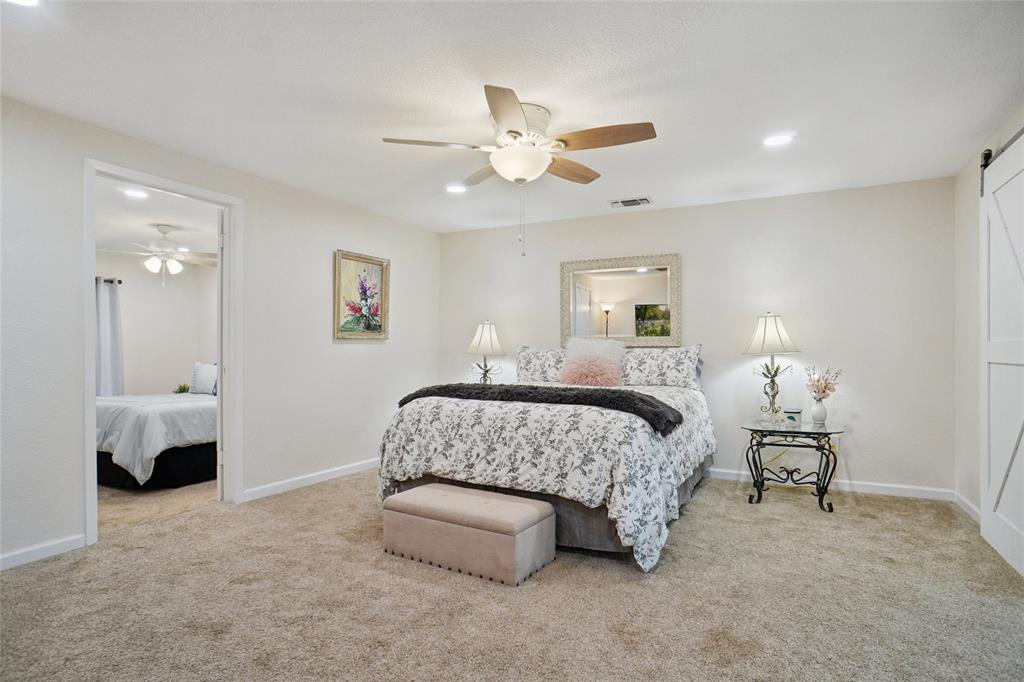 308 Half Moon Way Runaway Bay, TX 76426 - Photo 16 of 40 a bedroom with a bed and a chandelier