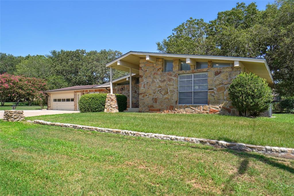 308 Half Moon Way Runaway Bay, TX 76426 - Photo 2 of 40 a view of a house with a yard