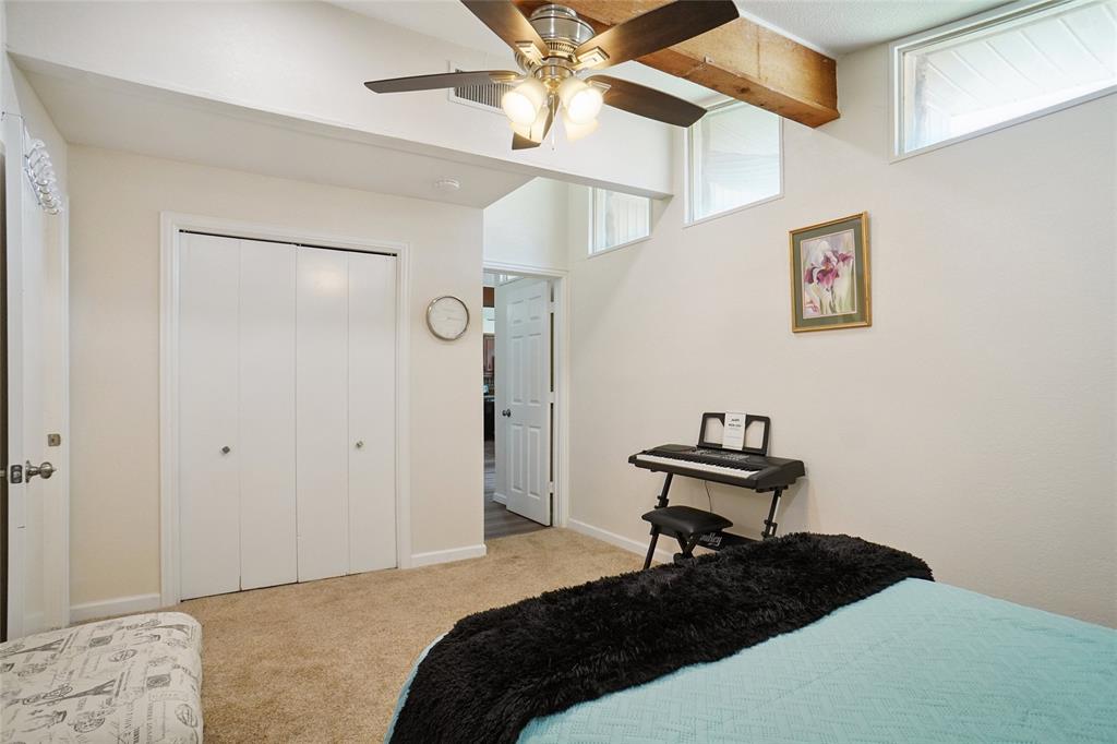 308 Half Moon Way Runaway Bay, TX 76426 - Photo 26 of 40 a bedroom with a bed and a table