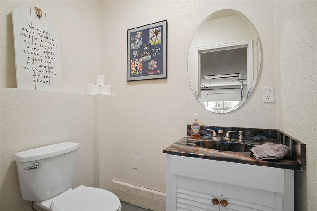 308 Half Moon Way Runaway Bay, TX 76426 - Photo 32 of 40 a bathroom with a toilet a sink and a mirror