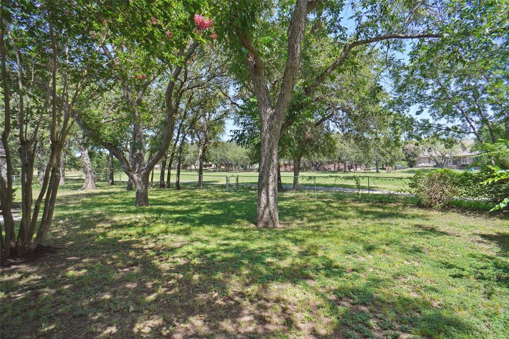 308 Half Moon Way Runaway Bay, TX 76426 - Photo 34 of 40 a view of outdoor space with trees all around