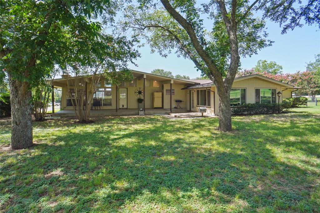 308 Half Moon Way Runaway Bay, TX 76426 - Photo 35 of 40 a front view of a house with a yard