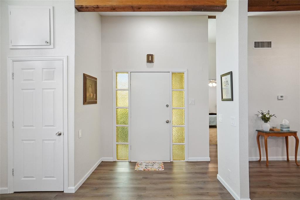 308 Half Moon Way Runaway Bay, TX 76426 - Photo 4 of 40 a view of a hallway with wooden floor and closet