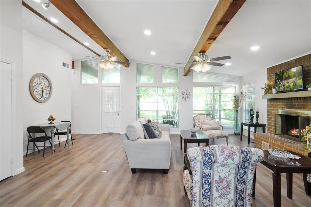 308 Half Moon Way Runaway Bay, TX 76426 - Photo 5 of 40 a living room with furniture a fireplace and a large window
