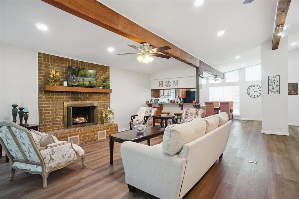 308 Half Moon Way Runaway Bay, TX 76426 - Photo 6 of 40 a living room with furniture a fireplace and a flat screen tv