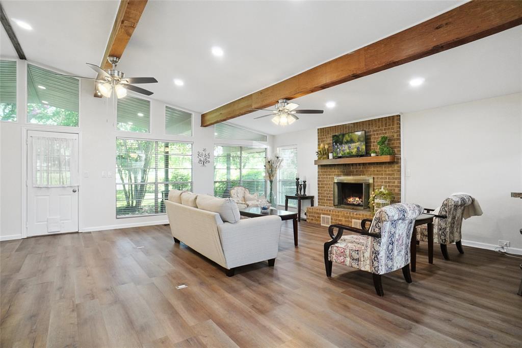 308 Half Moon Way Runaway Bay, TX 76426 - Photo 8 of 40 a living room with furniture a fireplace and a flat screen tv