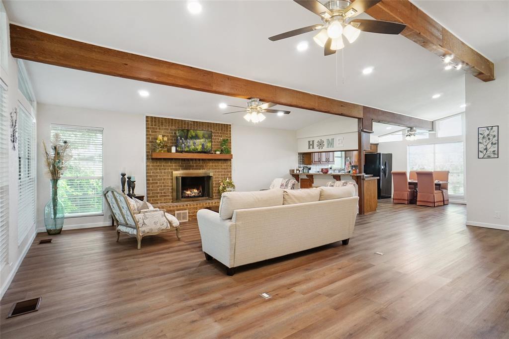 308 Half Moon Way Runaway Bay, TX 76426 - Photo 10 of 40 a living room with furniture a fireplace and a flat screen tv