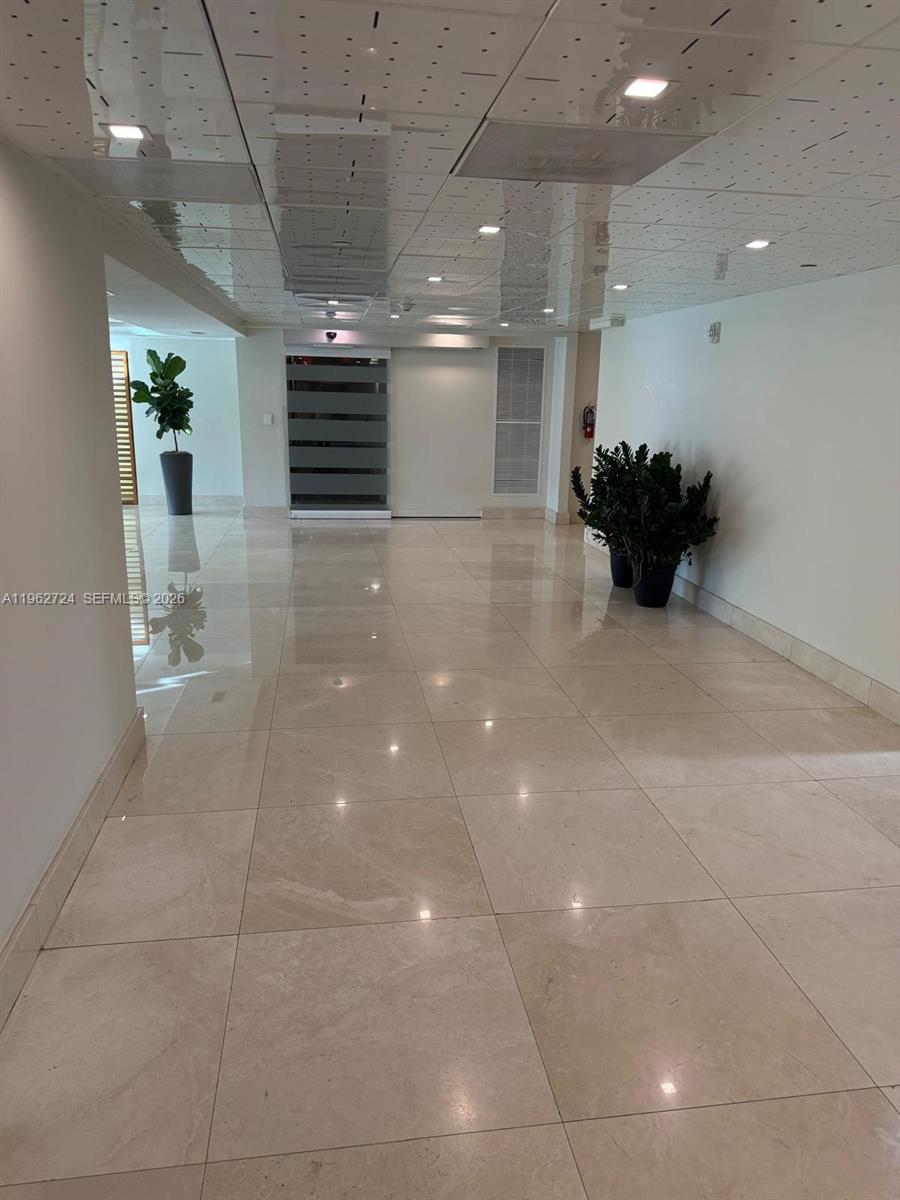540 Brickell Key Drive, Unit 1505 Miami, FL 33131 - Photo 2 of 17 a lobby with a chandelier and a rug