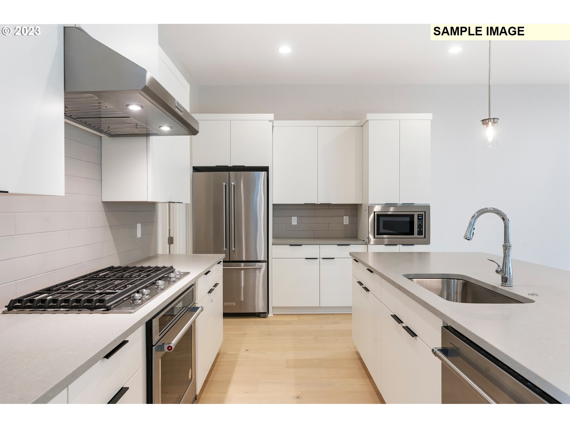 16060 Northwest Holman Way, Unit L79 Portland, OR 97229 - Photo 3 of 33 a kitchen that has a sink and a stove top oven