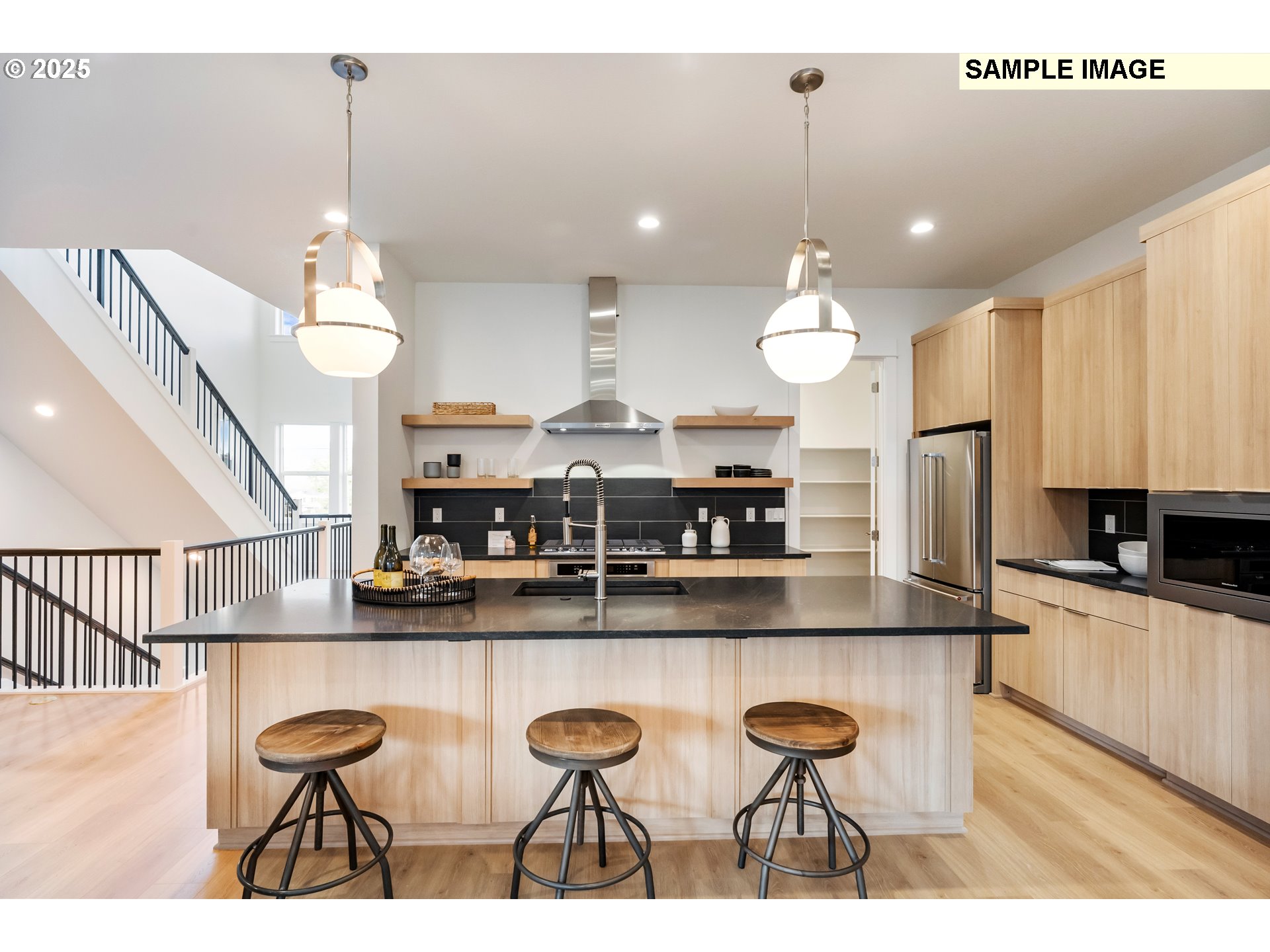 16060 Northwest Holman Way, Unit L79 Portland, OR 97229 - Photo 31 of 33 a kitchen with stainless steel appliances granite countertop a sink a stove top oven a counter space and cabinets