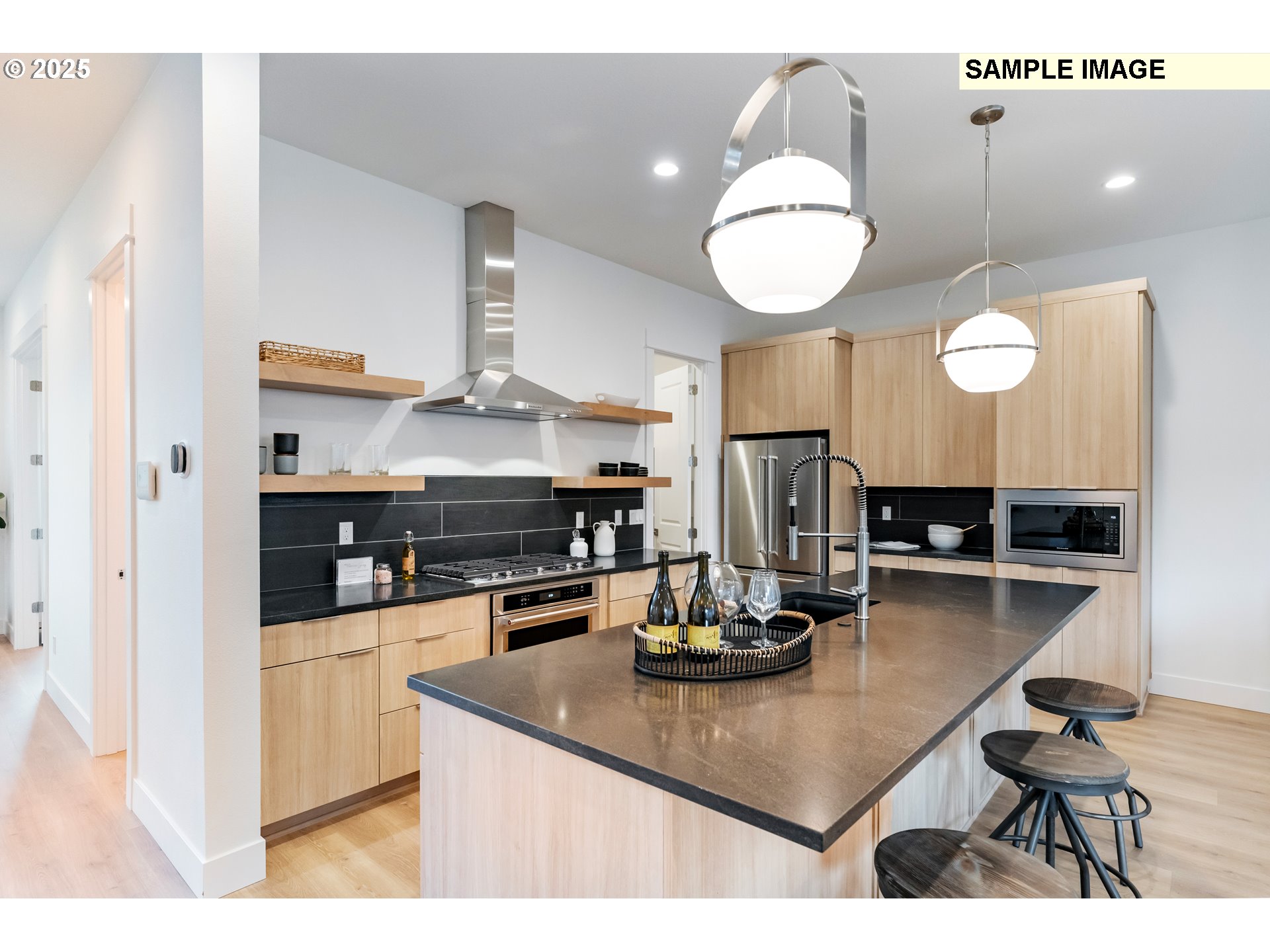 16060 Northwest Holman Way, Unit L79 Portland, OR 97229 - Photo 33 of 33 a kitchen with kitchen island granite countertop a stove a sink a dining table and chairs