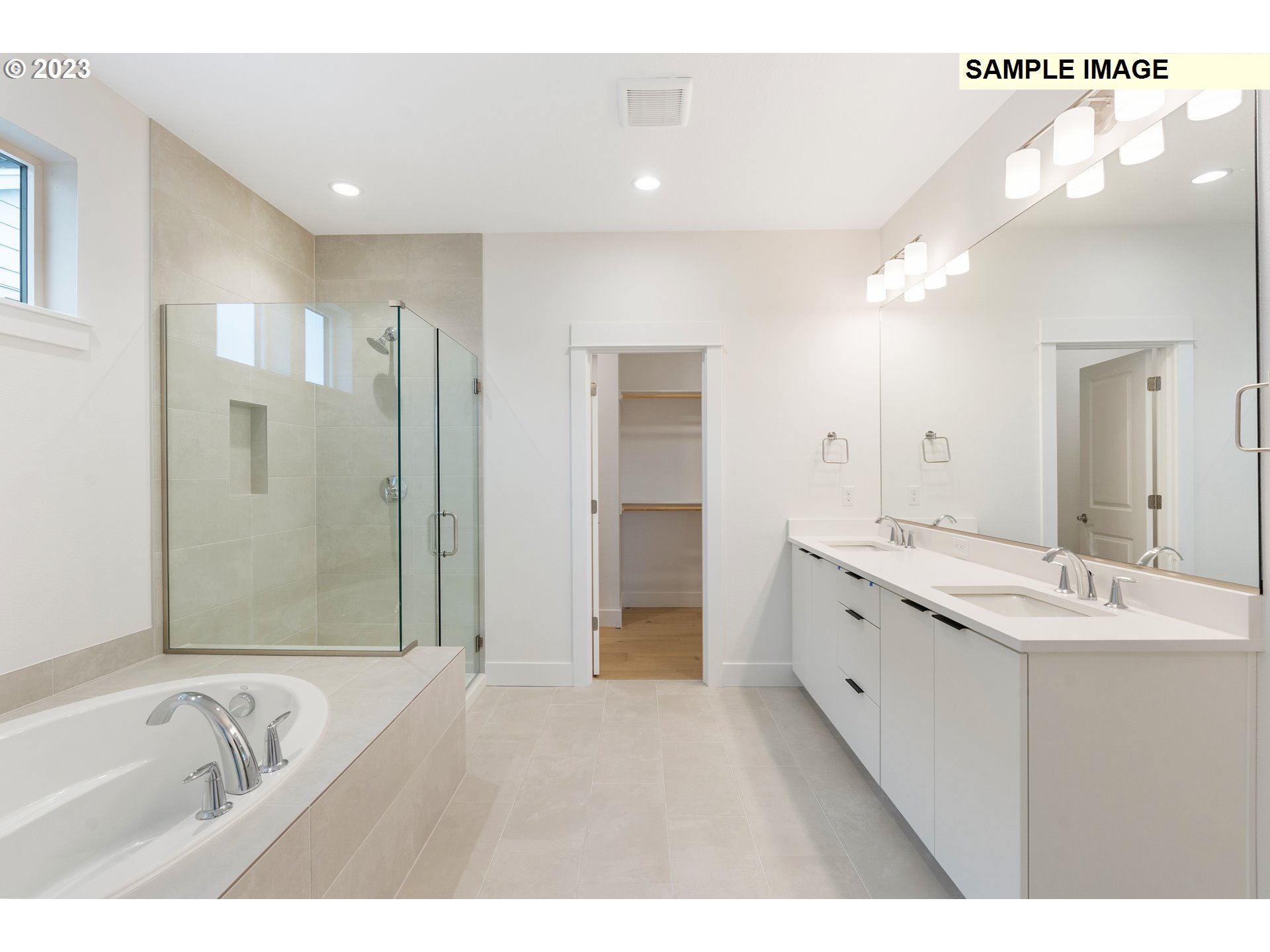 16060 Northwest Holman Way, Unit L79 Portland, OR 97229 - Photo 10 of 33 a bathroom with a tub sink double and mirror