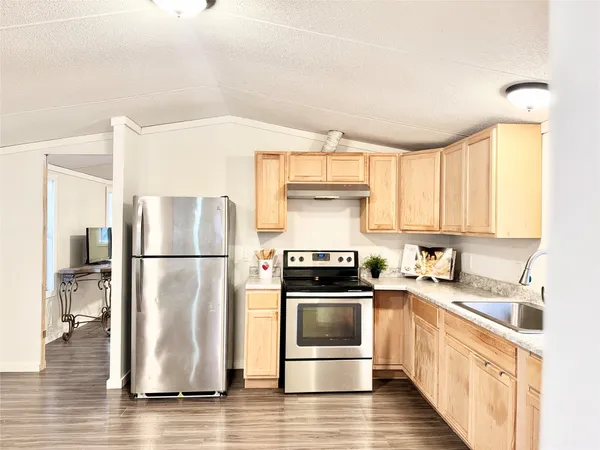 a kitchen with a dining table chairs and white cabinets