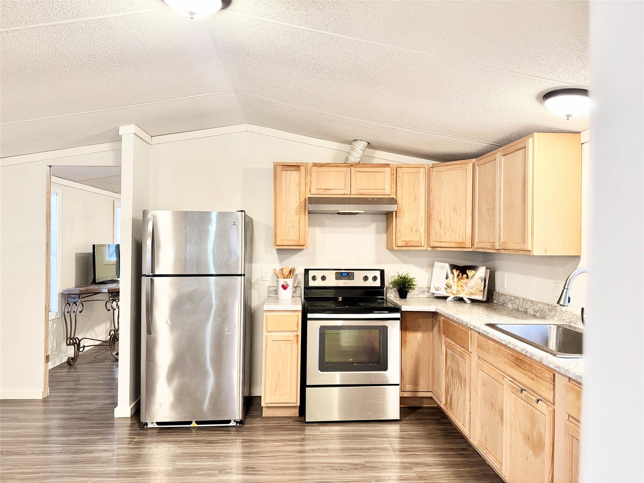 6739 Taylorsville Road Dale, TX 78616 - Photo 12 of 37 a kitchen with a refrigerator sink and cabinets