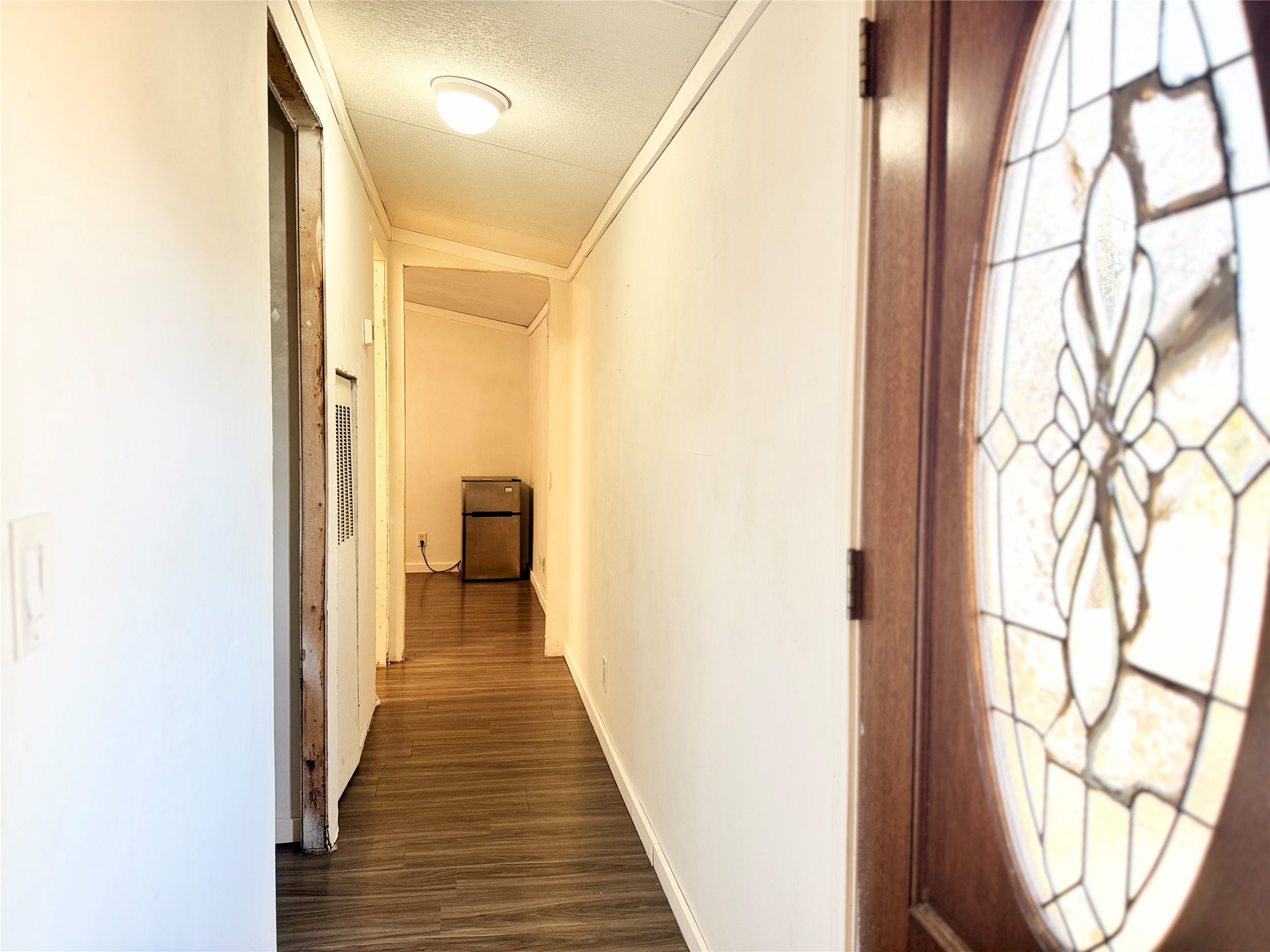 6739 Taylorsville Road Dale, TX 78616 - Photo 14 of 37 a view of a hallway with wooden floor and staircase