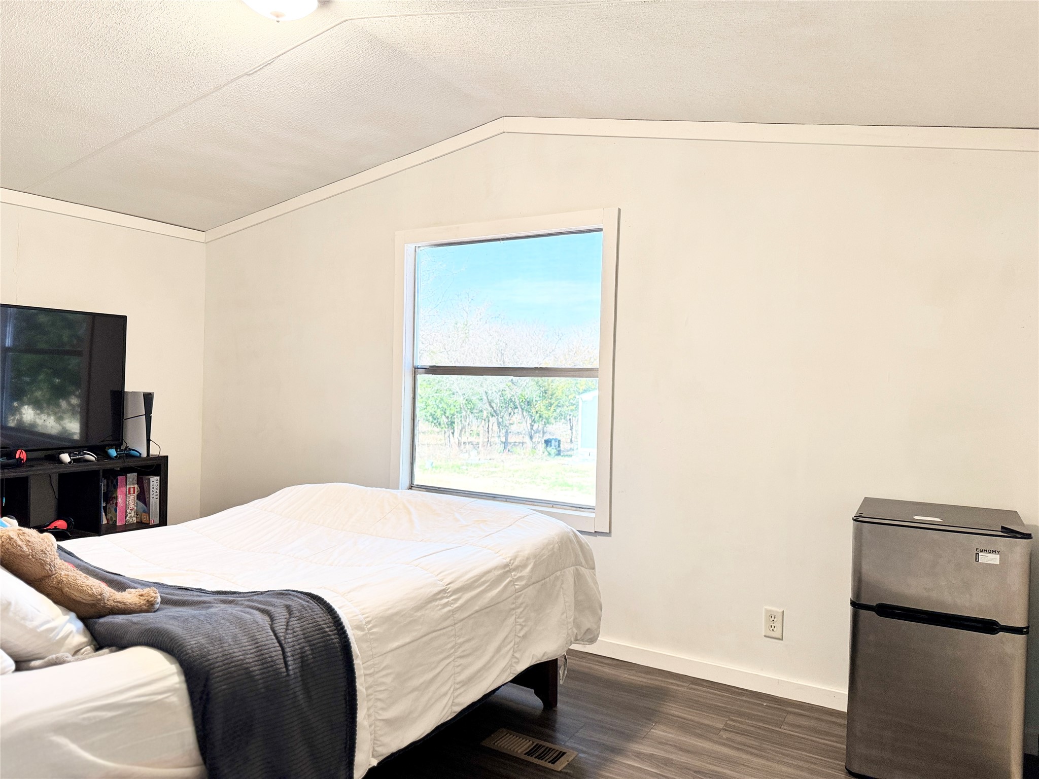 6739 Taylorsville Road Dale, TX 78616 - Photo 20 of 37 a bedroom with a bed and a flat screen tv