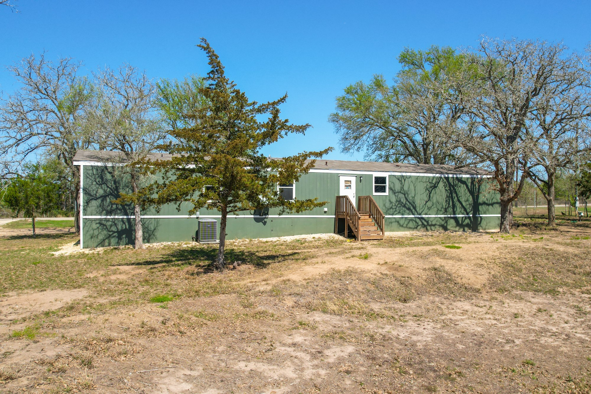 6739 Taylorsville Road Dale, TX 78616 - Photo 25 of 37 a view of a house with backyard and a tree