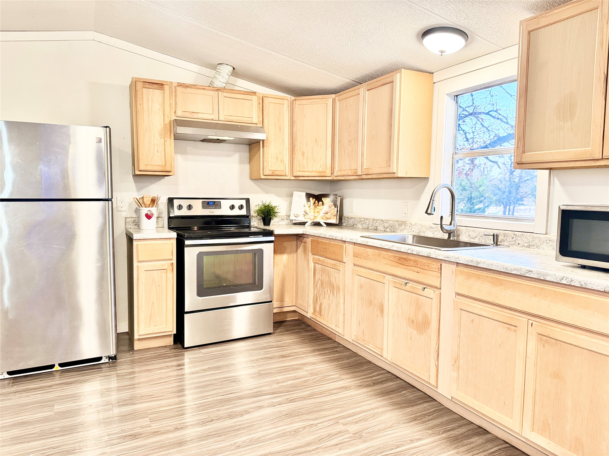 6739 Taylorsville Road Dale, TX 78616 - Photo 10 of 37 a kitchen with a white cabinets and white appliances
