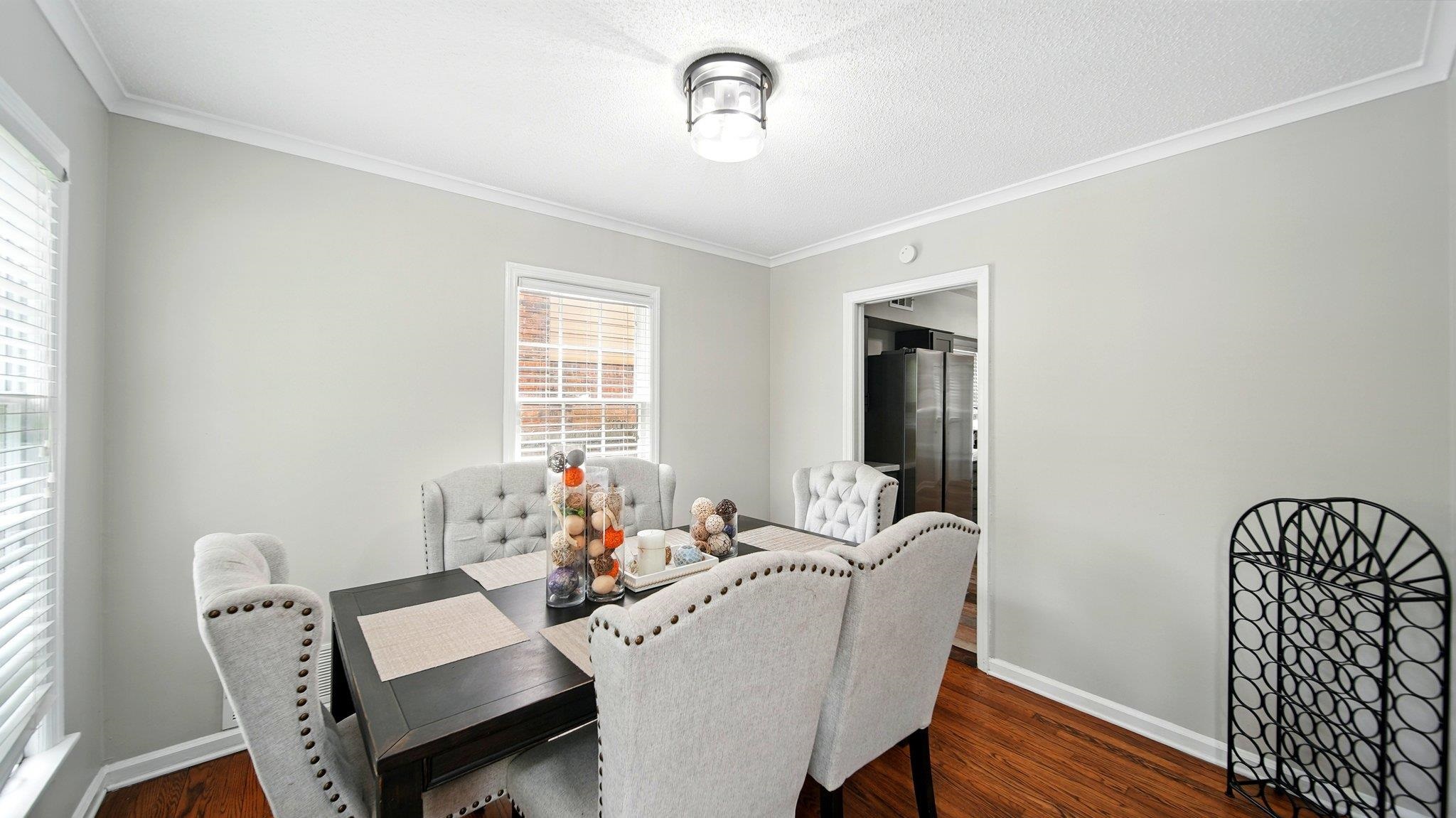 359 South Fenwick Road Memphis, TN 38111 - Photo 9 of 31 Dining space featuring crown molding, dark wood-type flooring, and a textured ceiling