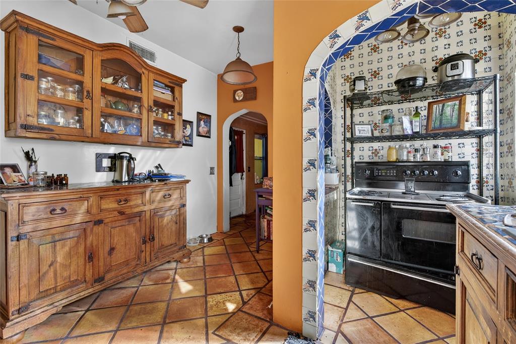 1321 28th Street North St. Petersburg, FL 33713 - Photo 12 of 21 a kitchen with stainless steel appliances granite countertop a stove and cabinets