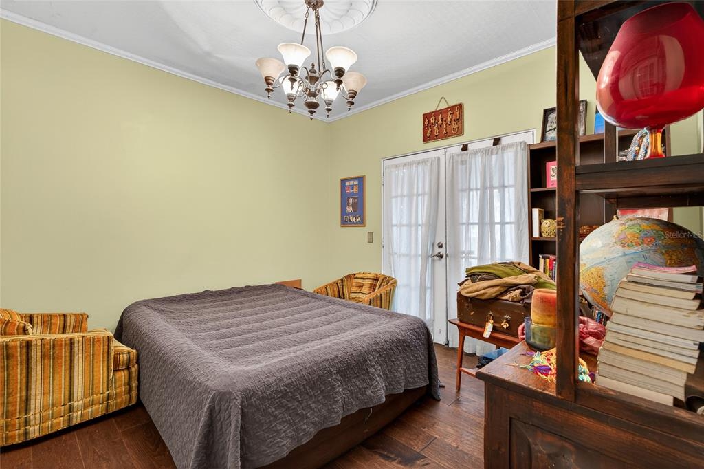 1321 28th Street North St. Petersburg, FL 33713 - Photo 16 of 21 a bedroom with a bed and dresser with wooden floor