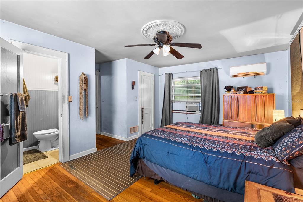 1321 28th Street North St. Petersburg, FL 33713 - Photo 18 of 31 a bedroom with a bed and wooden floor