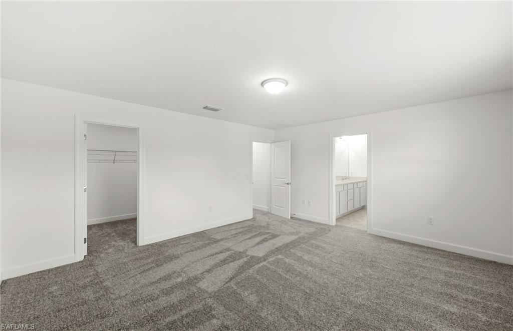 15827 Northridge Road Punta Gorda, FL 33982 - Photo 15 of 27 an empty room with windows and entrance to other room