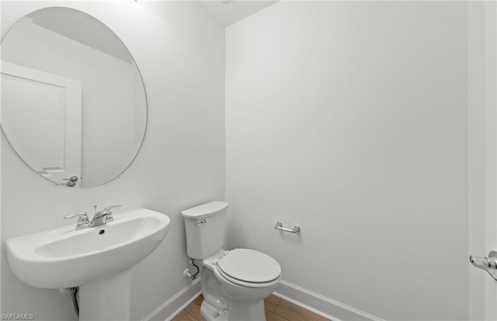 15827 Northridge Road Punta Gorda, FL 33982 - Photo 23 of 27 a bathroom with a sink a toilet and mirror