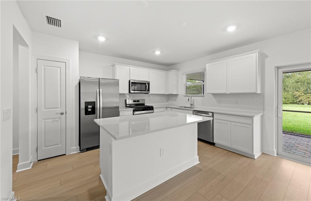 15827 Northridge Road Punta Gorda, FL 33982 - Photo 5 of 27 a kitchen with cabinets and stainless steel appliances