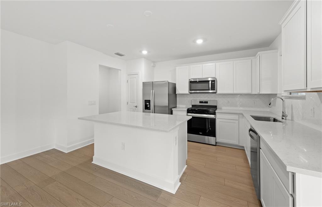 15827 Northridge Road Punta Gorda, FL 33982 - Photo 6 of 27 a kitchen with granite countertop white cabinets and stainless steel appliances