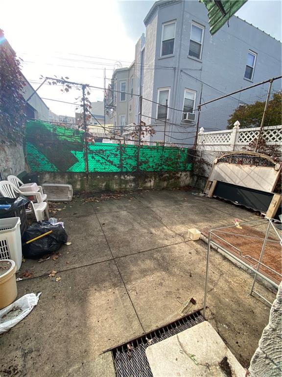 2308 Bath Avenue Brooklyn, NY 11214 - Photo 13 of 14 a view of a patio with table and chairs and potted plants