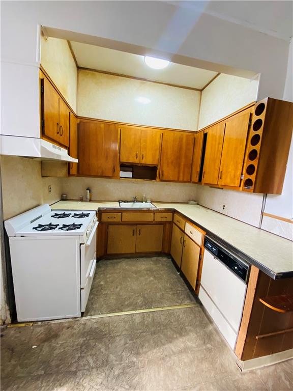 2308 Bath Avenue Brooklyn, NY 11214 - Photo 6 of 14 a kitchen with a stove a sink and a refrigerator
