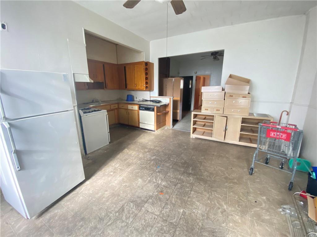 2308 Bath Avenue Brooklyn, NY 11214 - Photo 9 of 14 a kitchen with refrigerator and cabinets