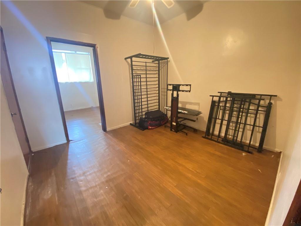 2308 Bath Avenue Brooklyn, NY 11214 - Photo 10 of 14 a view of an empty room with wooden floor
