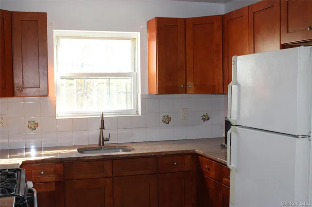a kitchen with stainless steel appliances granite countertop a refrigerator sink and cabinets