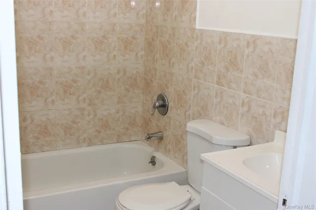 a bathroom with a sink a toilet and bathtub