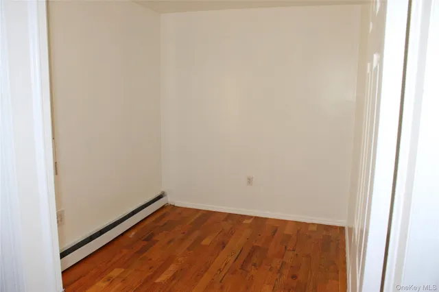 a view of an empty room and wooden floor