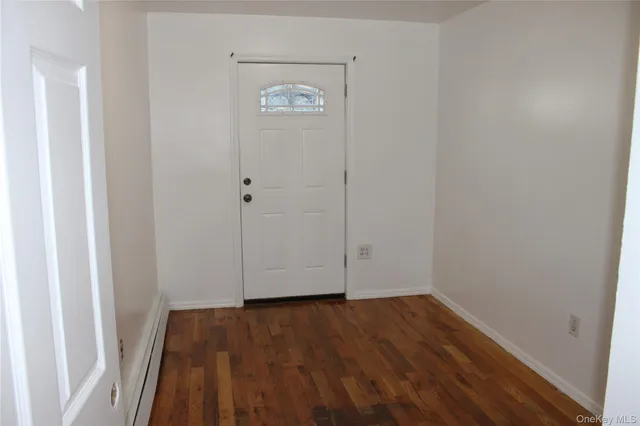 a view of room with wooden floor