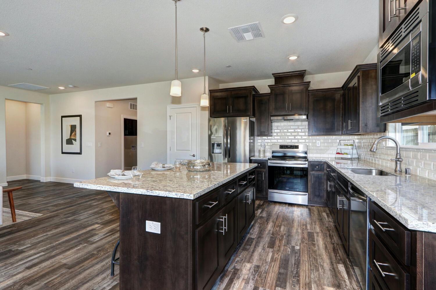 937 Norman Road Galt, CA 95632 - Photo 11 of 15 a kitchen with stainless steel appliances kitchen island granite countertop a sink stove and cabinets
