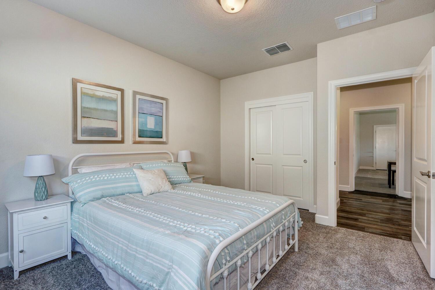 937 Norman Road Galt, CA 95632 - Photo 15 of 15 a bedroom with a bed and a chandelier