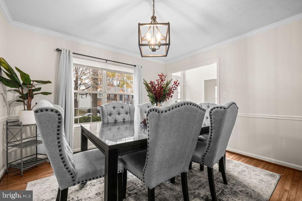 9803 Bald Hill Road Bowie, MD 20721 - Photo 12 of 55 a view of a dining room with furniture a chandelier and wooden floor