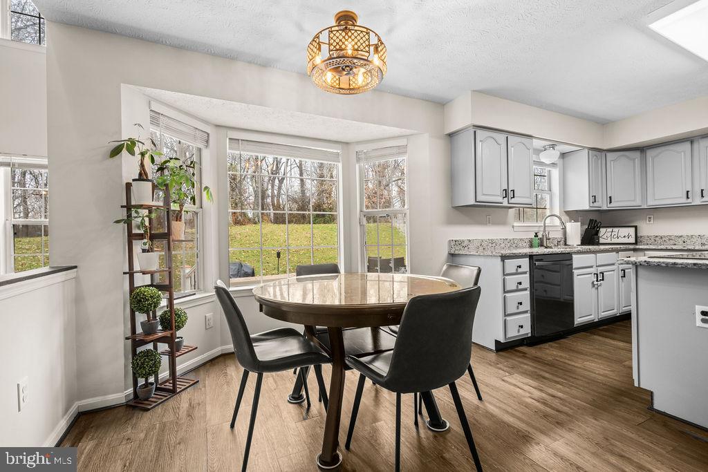 9803 Bald Hill Road Bowie, MD 20721 - Photo 14 of 55 a dining room with furniture a window and wooden floor
