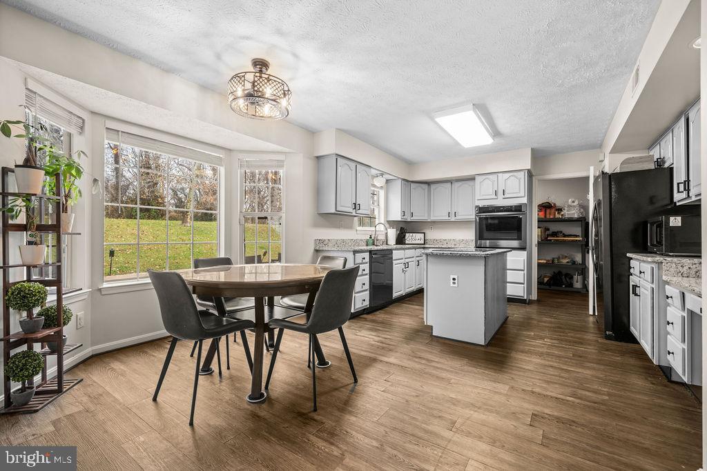 9803 Bald Hill Road Bowie, MD 20721 - Photo 15 of 55 a view of a dining room with furniture window and wooden floor
