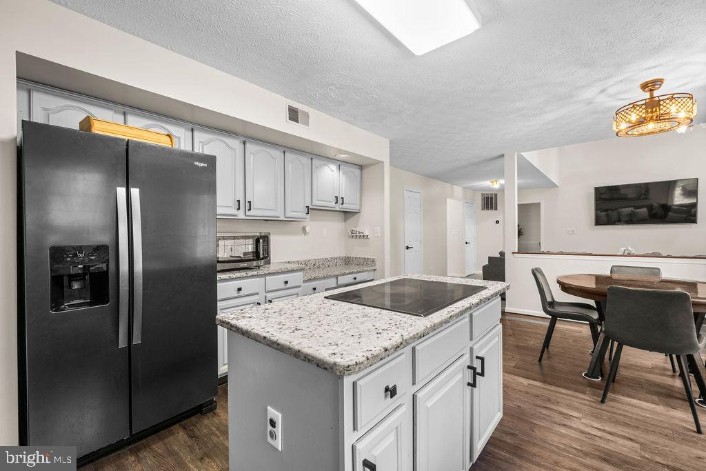 9803 Bald Hill Road Bowie, MD 20721 - Photo 18 of 55 a kitchen with stainless steel appliances granite countertop a sink stove and refrigerator