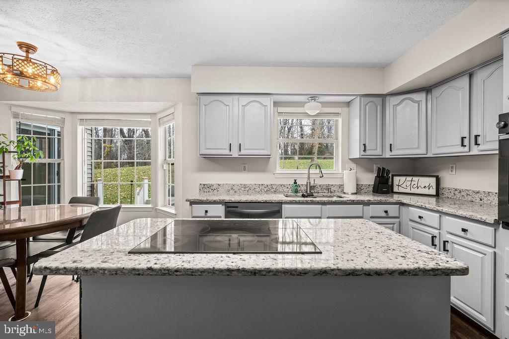 9803 Bald Hill Road Bowie, MD 20721 - Photo 19 of 55 a kitchen with granite countertop kitchen island a counter space a sink and a large window